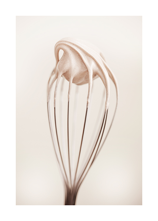  – Photograph of a cream covered whisk against a light background